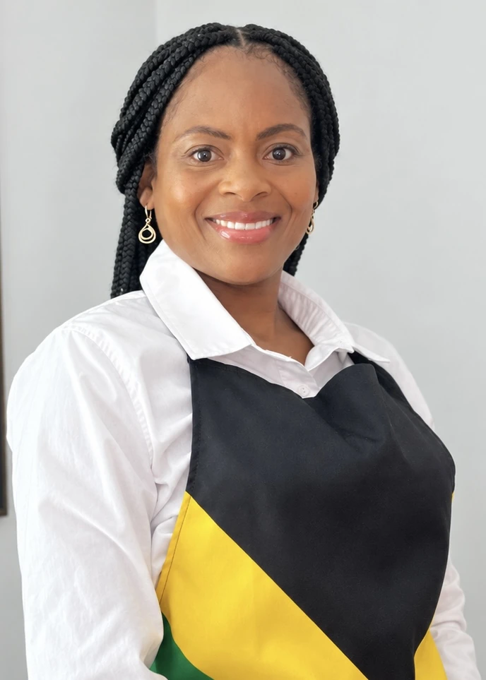 Sheba, the creator and cook behind Will Work for Oxtail, wearing her Jamaican apron